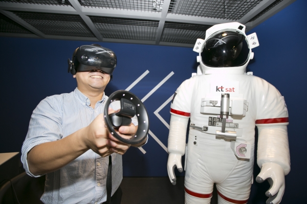 KT SAT 관계자가 VR 기기를 이용해 인공 위성 발사 현장과 우주 상공 여행을 가상 체험하고 있는 모습이다. [KT 제공]